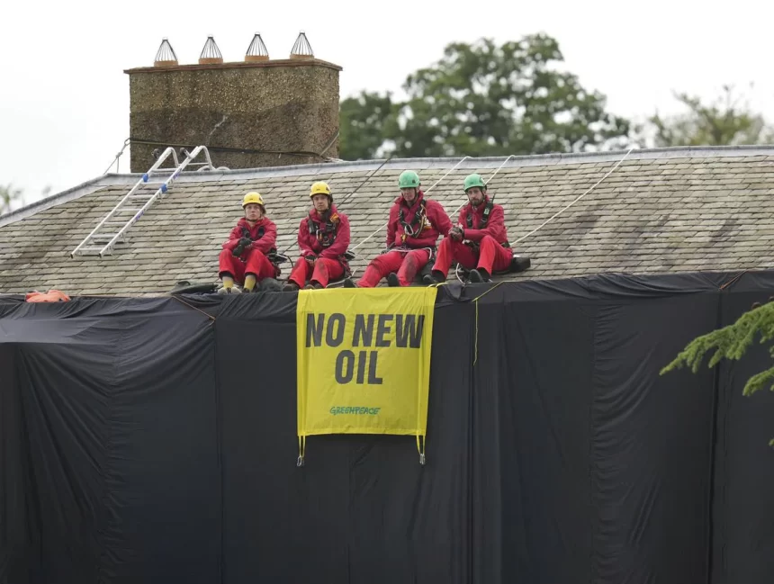 Greenpeace demonstrators drape U.K. pm ‘s house in black to protest oil expansion